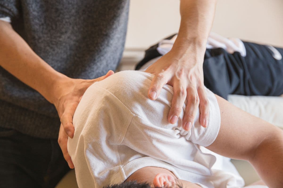 Physiotherapist providing hands-on shoulder rehabilitation